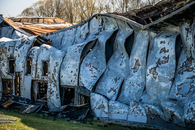 View of old abandoned car on field