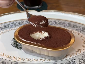 Close-up of tiramisu on the spoon on table