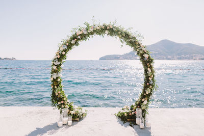 Scenic view of flower decoration against sea