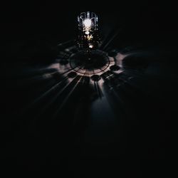 Low angle view of illuminated chandelier in dark room