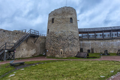 View of old building against cloudy sky