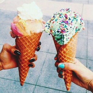 ice cream cone, ice cream, frozen food, cone, dairy product, human hand, sweet, hand, sweet food, human body part, frozen, dessert, holding, indulgence, food, food and drink, unhealthy eating, freshness, unrecognizable person, temptation, body part, finger, nail, frozen sweet food