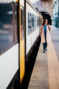 Full length of woman at railroad station
