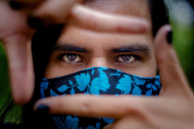 Close-up portrait of man covering face