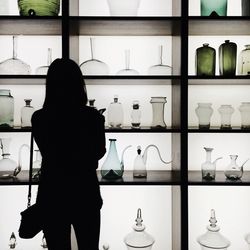 Rear view of woman standing at home