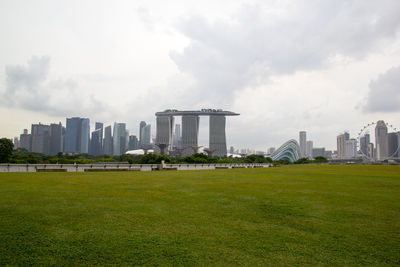 View of buildings in city against cloudy sky