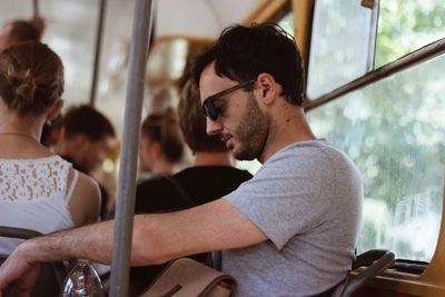 Young man and woman sitting in bus