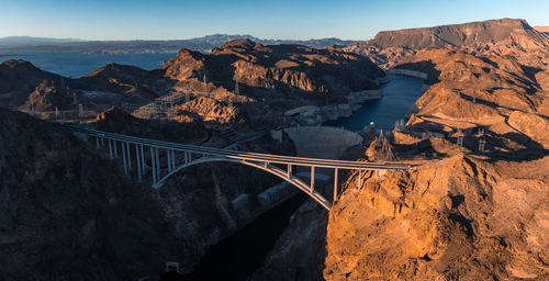 Bridge over mountains against sky