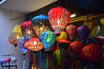 Illuminated lanterns hanging at market stall