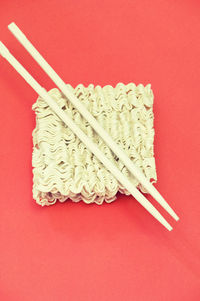 High angle view of bread on red background