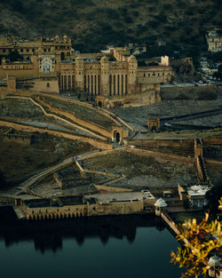 High angle view of buildings by lake in city