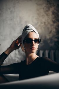 Young woman wearing sunglasses at home