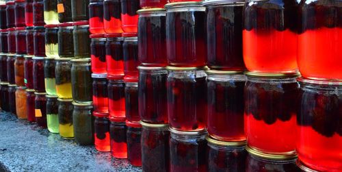 Close-up of juice jars stacks at market stall