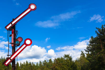 Low angle view of signboard against sky