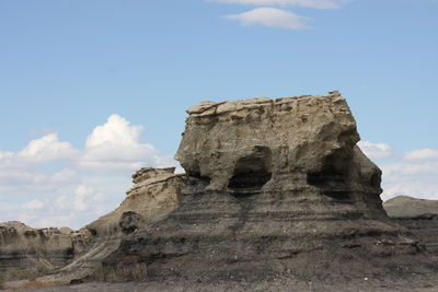 Low angle view of rock formation against sky