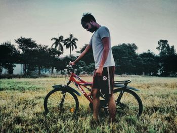 Man riding bicycle on field