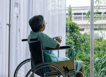 Patient sitting on wheel chair in hospital