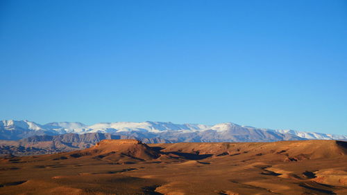 Scenic view of mountains against clear blue sky