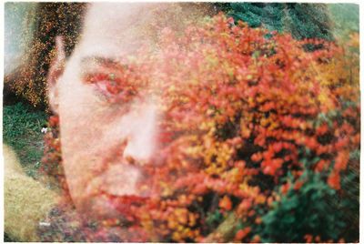 Close-up portrait of man on flowering plants