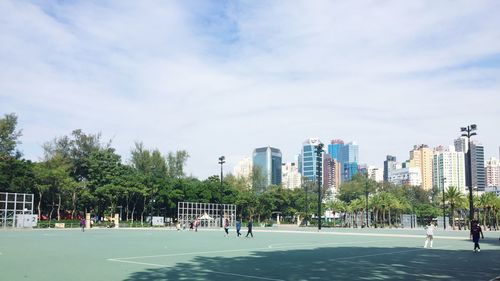Buildings in city against cloudy sky