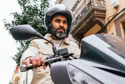 Portrait of young man riding bicycle