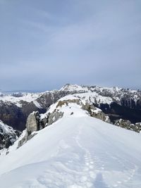 Scenic view of snow covered mountains against sky