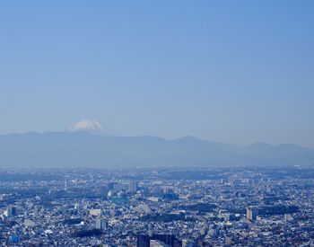 High angle view of buildings against clear blue sky