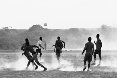 People playing soccer on field