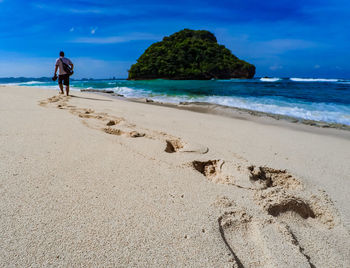 Man on beach against sky