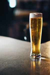 Close-up of beer glass on table