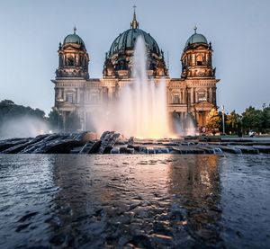 Water fountain in front of historical building