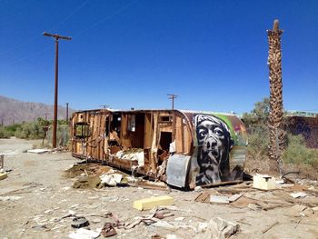 Abandoned building against clear blue sky