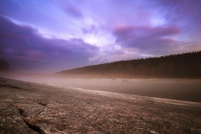 Scenic view of landscape against sky during winter