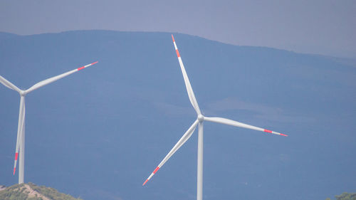 Low angle view of wind turbine against sky