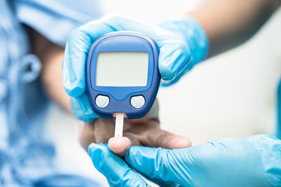 Cropped hand of person holding stethoscope