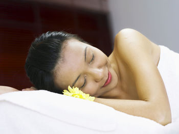 Woman having spa treatment while lying on massage table