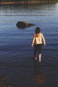 Full length of woman standing in lake