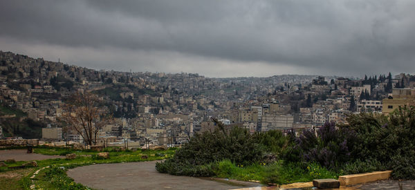 View of townscape against cloudy sky