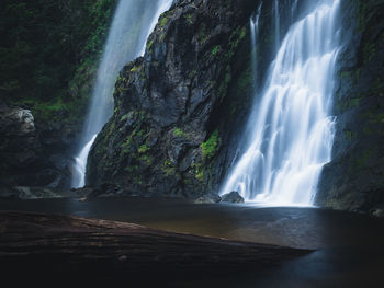 Scenic view of khlong lan waterfall. flowing water stream on mossy rock. kamphaeng phet, thailand.