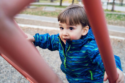 High angle view of boy climbing on ladder in playground