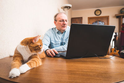 Portrait of a young man using laptop