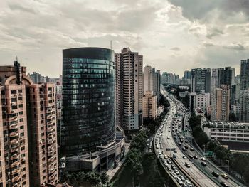 High angle view of street amidst buildings in city against sky