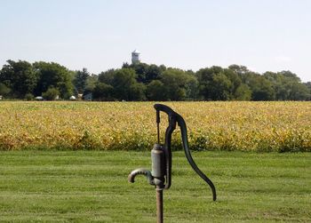 Old antique water pump at field