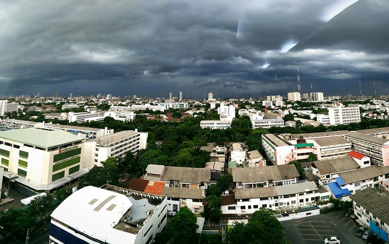 building exterior, architecture, cityscape, built structure, city, crowded, high angle view, sky, residential district, cloud - sky, residential building, residential structure, cloudy, house, town, city life, cloud, townscape, community, human settlement