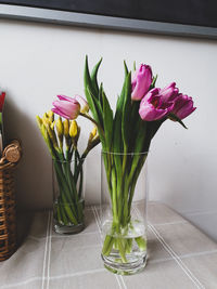 Close-up of pink roses in vase on table at home