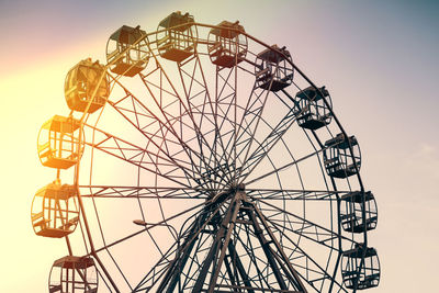 Low angle view of ferris wheel against sky