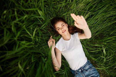Low angle view of young woman sitting on grass