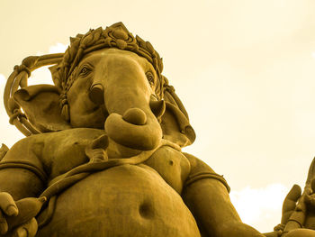 Low angle view of statue against sky
