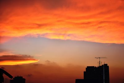 Low angle view of silhouette buildings against sky during sunset