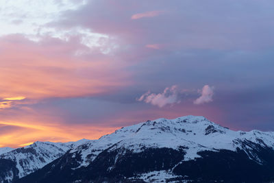 Scenic view of snowcapped mountains against sky during sunset